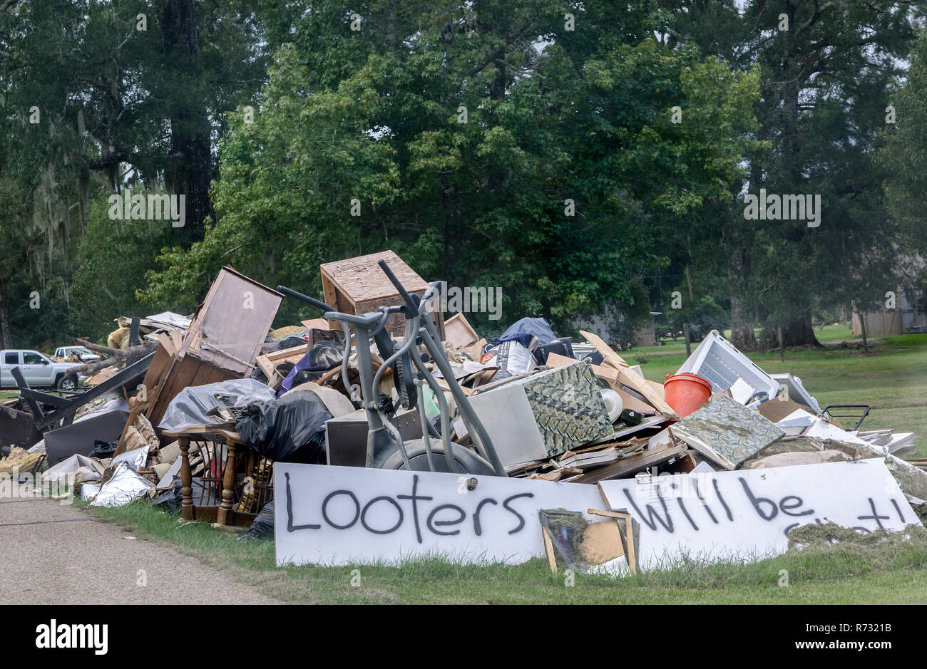 Un cartel pintado a mano advierte a los saqueadores que será rodada que roben desde un montón de escombros de inundación, el 4 de septiembre de 2016, en Denham Springs, Louisiana. Foto de stock