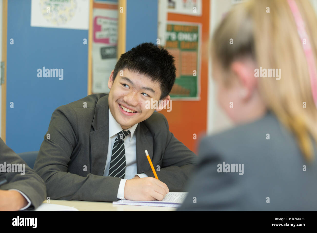 Alumno de 14 años de edad en un aula de clase, etnia asiática oriental, REINO UNIDO Foto de stock