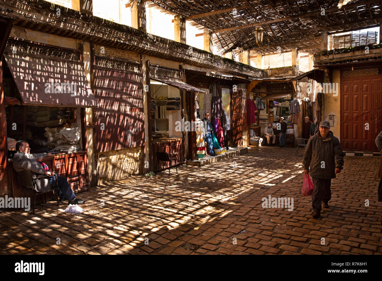 Marruecos, Fez, Fes el Bali, Medina, Talaa Kebira, sombra parcial en la tienda de ropa local patio Foto de stock