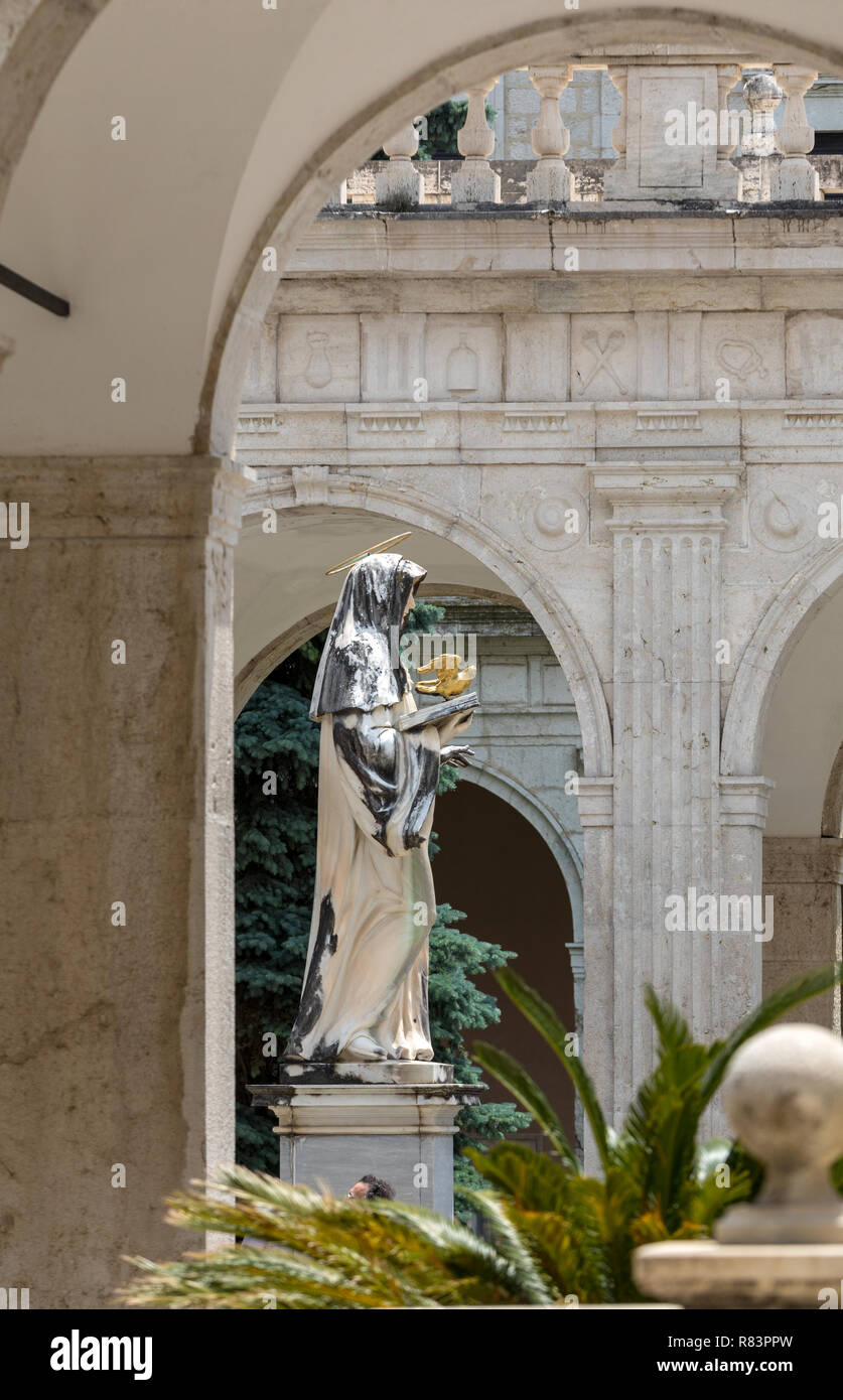 El Montecassino, Italia - Junio 17, 2017: la estatua de mármol de Santa Escolástica por P. Campi de Carrara, en el Claustro de Bramante, abadía benedictina de Montec Foto de stock