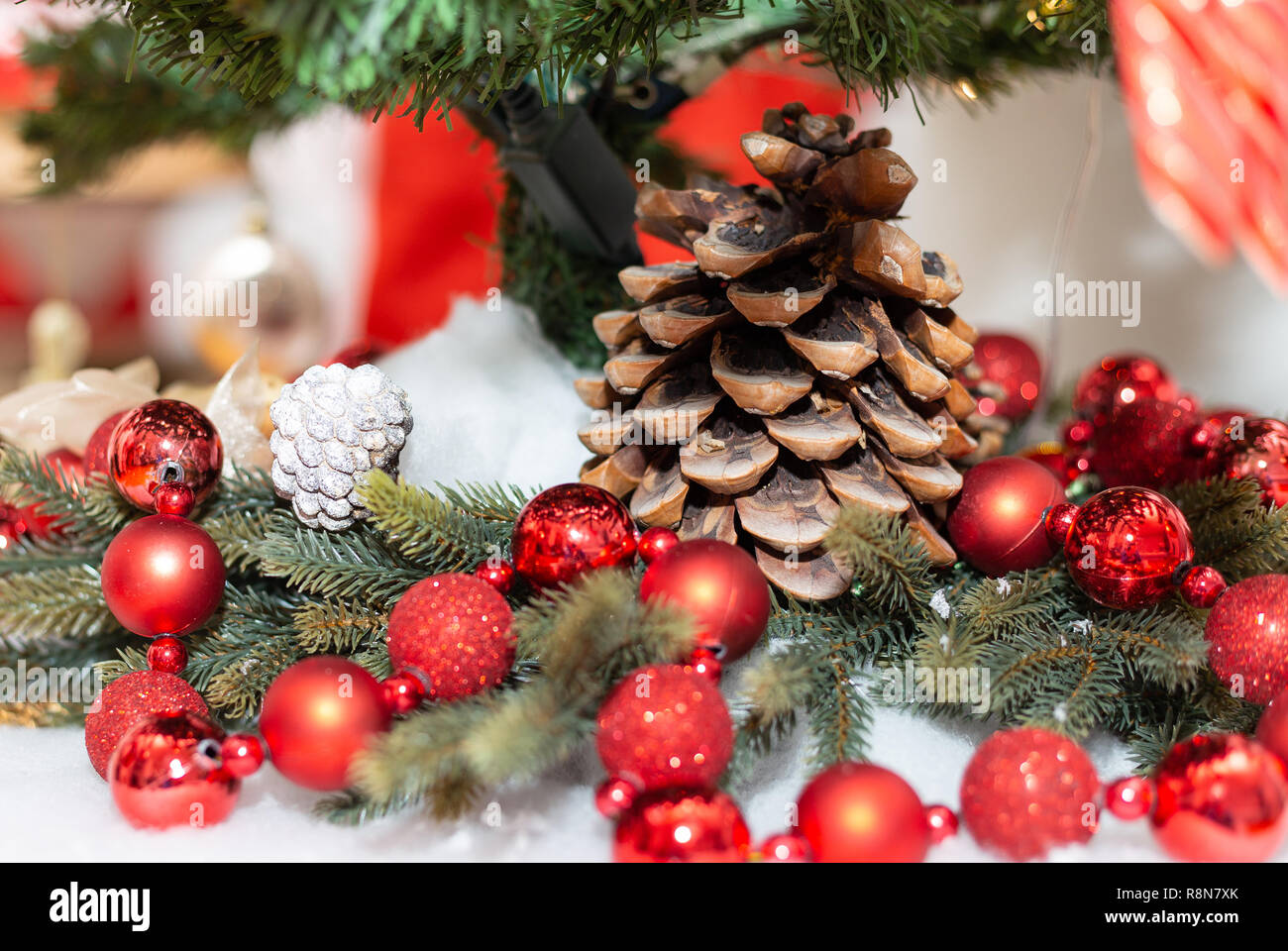 Decoración de Navidad en un árbol de pino artificial, big pinecone, dorado  y rojo linternas Fotografía de stock - Alamy