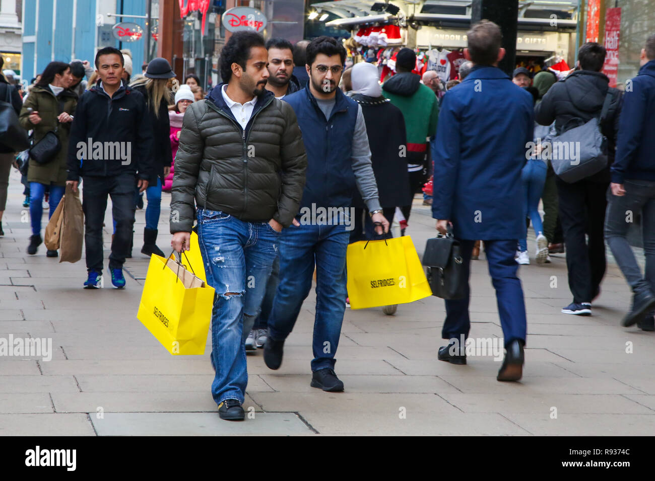 Los compradores son vistos con bolsas de compras de Selfridges en la Oxford Street de Londres con 6 días para el día de Navidad. Los minoristas esperan una avalancha de compradores en el periodo previo a la Navidad como la venta en muchas tiendas han empezado. Foto de stock