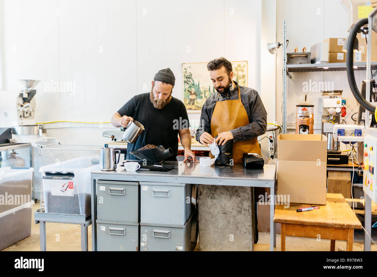 Dos hombres hacer café en una cocina comercial en Suecia Foto de stock