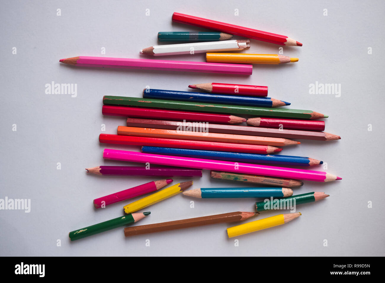Utiliza los lápices de colores sobre un fondo blanco. Foto de stock