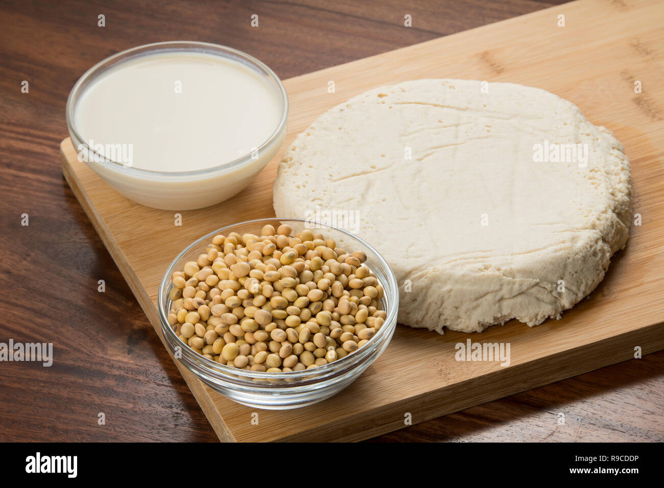 Comida : tazones de leche de soja, tofu y soja aislado sobre fondo de madera Foto de stock