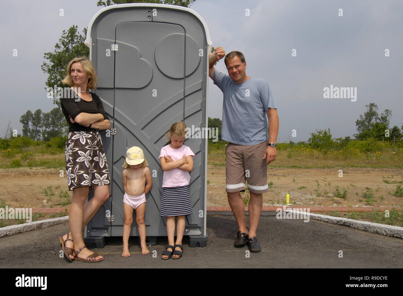 23.07.2006, Alemania, Sajonia, - Eine Familie steht vor einem Dixi-Klo auf der Baustelle ihres Einfamilienhauses. 0Ux060723D360CAROEX.JPG GT [MODEL VOLVER Foto de stock