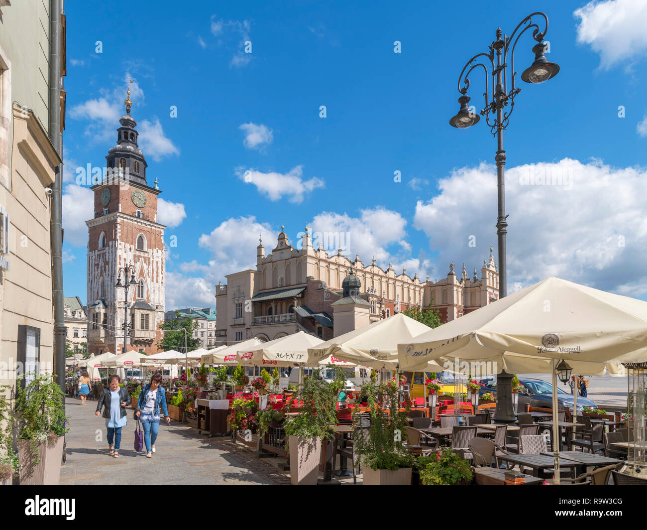 Cafés en la acera en frente de la torre del Ayuntamiento (Wieża ratuszowa) y Sukiennice (Sukiennice) en la plaza principal (Rynek Glówny ), Cracovia, Polonia Foto de stock