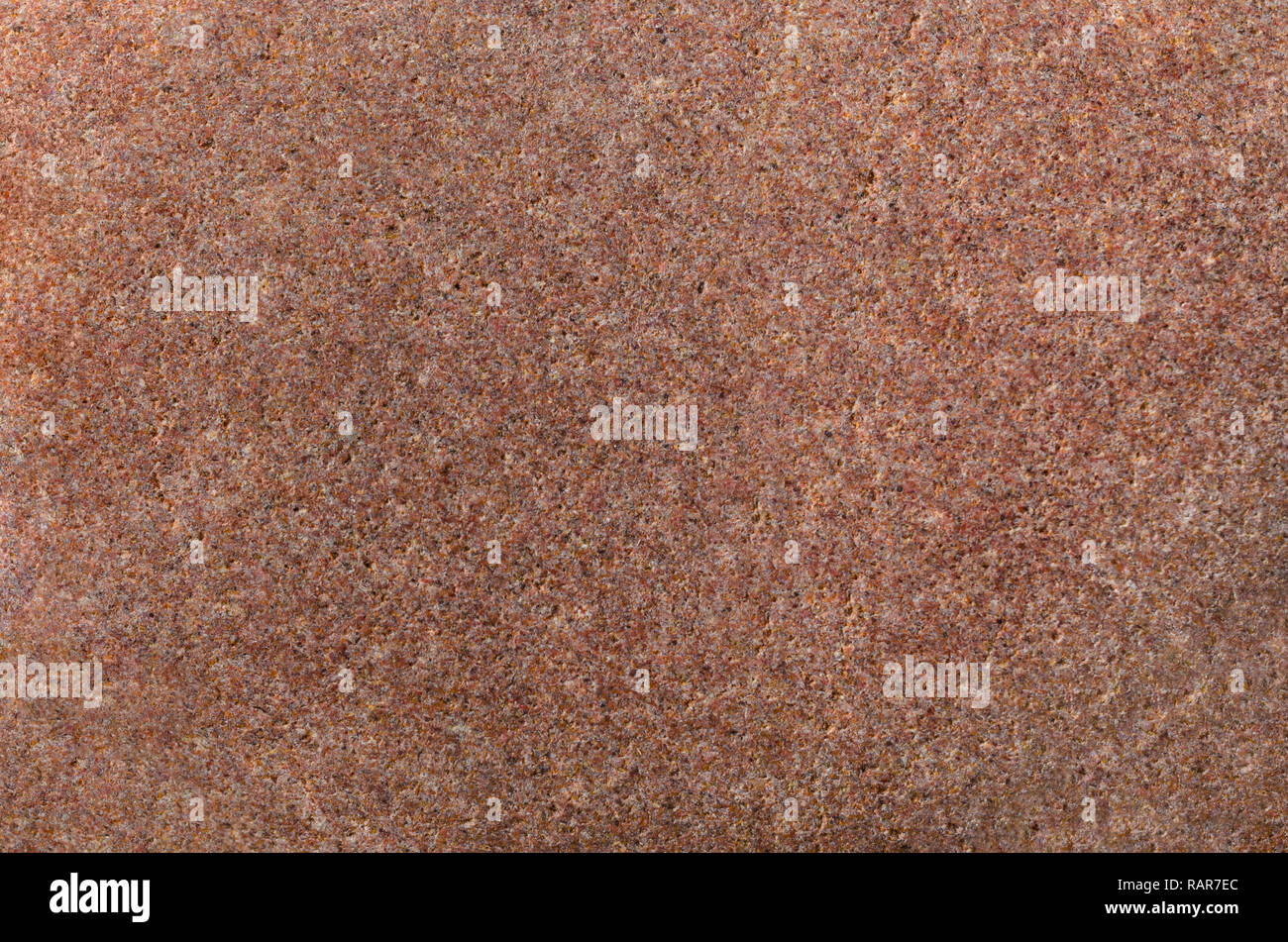 Muy de cerca (macro) de textura de piedra en tonos marrón y rosado. Foto de stock