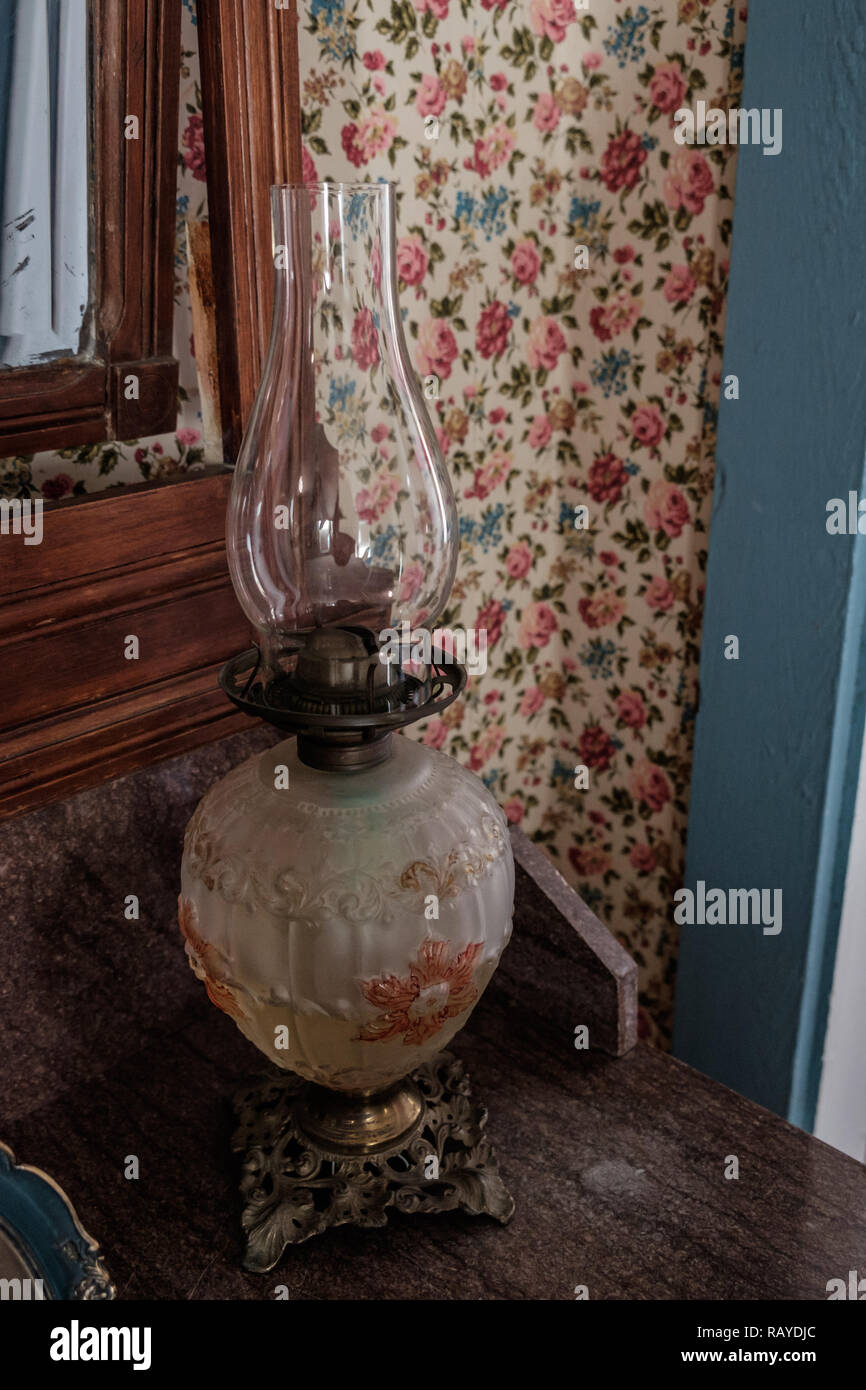 Lámpara de aceite de vidrio decorativos antiguos con fondo de pantalla retro en la histórica Casa tejano, Castaños Square Historic Village, McKinney, Texas. Foto de stock