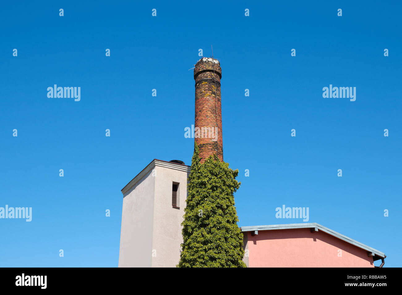 Antigua chimenea de ladrillo contra el azul cielo despejado. Foto de stock