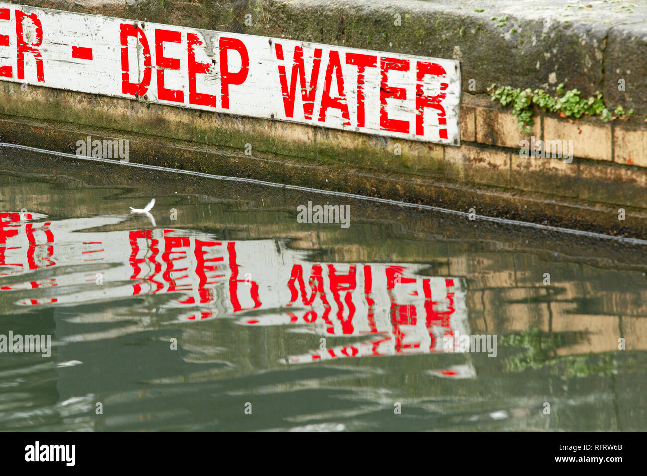Un cartel rojo y blanco en el lateral de una advertencia al canal de aguas profundas. Foto de stock