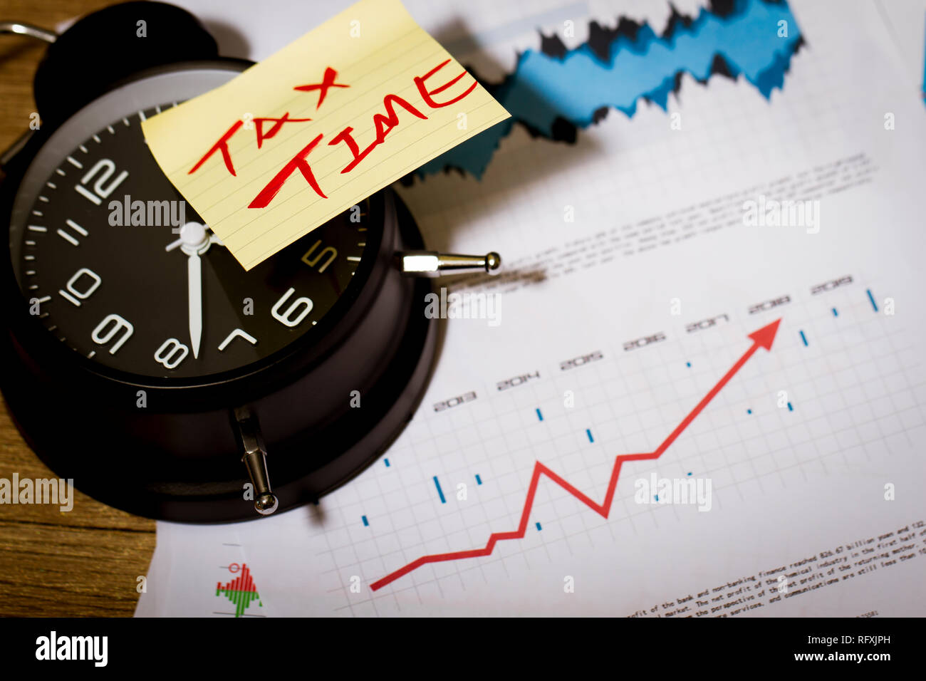 Reloj con dinero, impuestos, cuadro de estadísticas de la bolsa Fotografía  de stock - Alamy