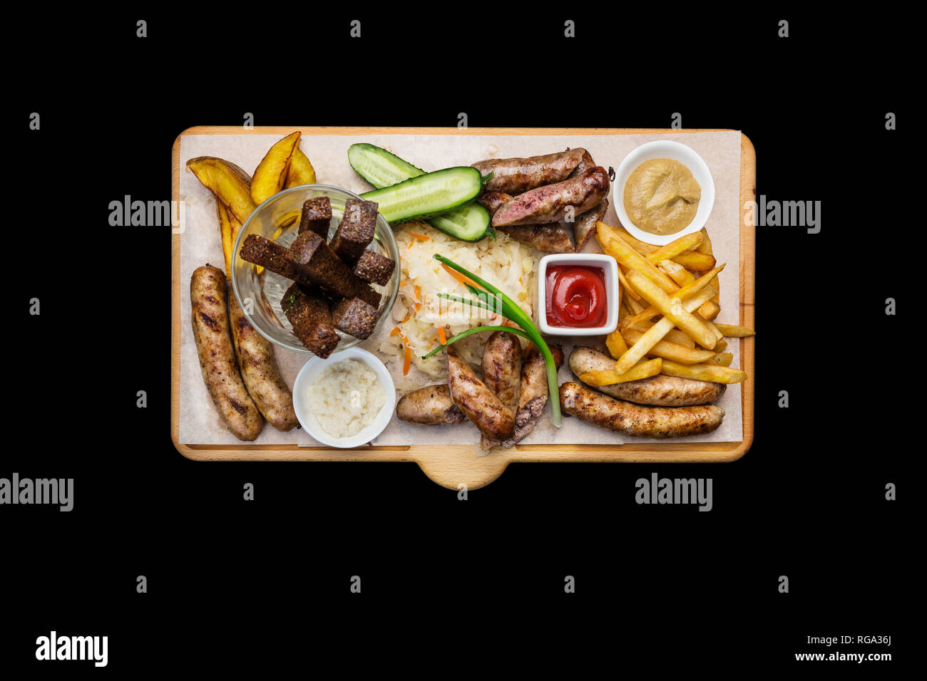 Bocadillos de cerveza. Salchichas asadas y papas fritas con tomate y salsa de barbacoa, servido en la tabla de cortar. Foto de stock