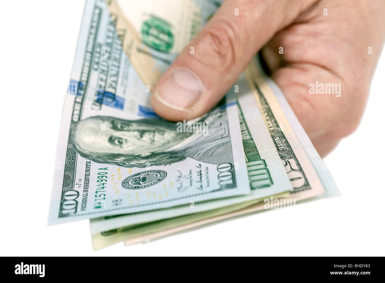 US Dollar billetes sosteniendo en la mano aislado sobre fondo blanco, el trazado de recorte incluido Foto de stock