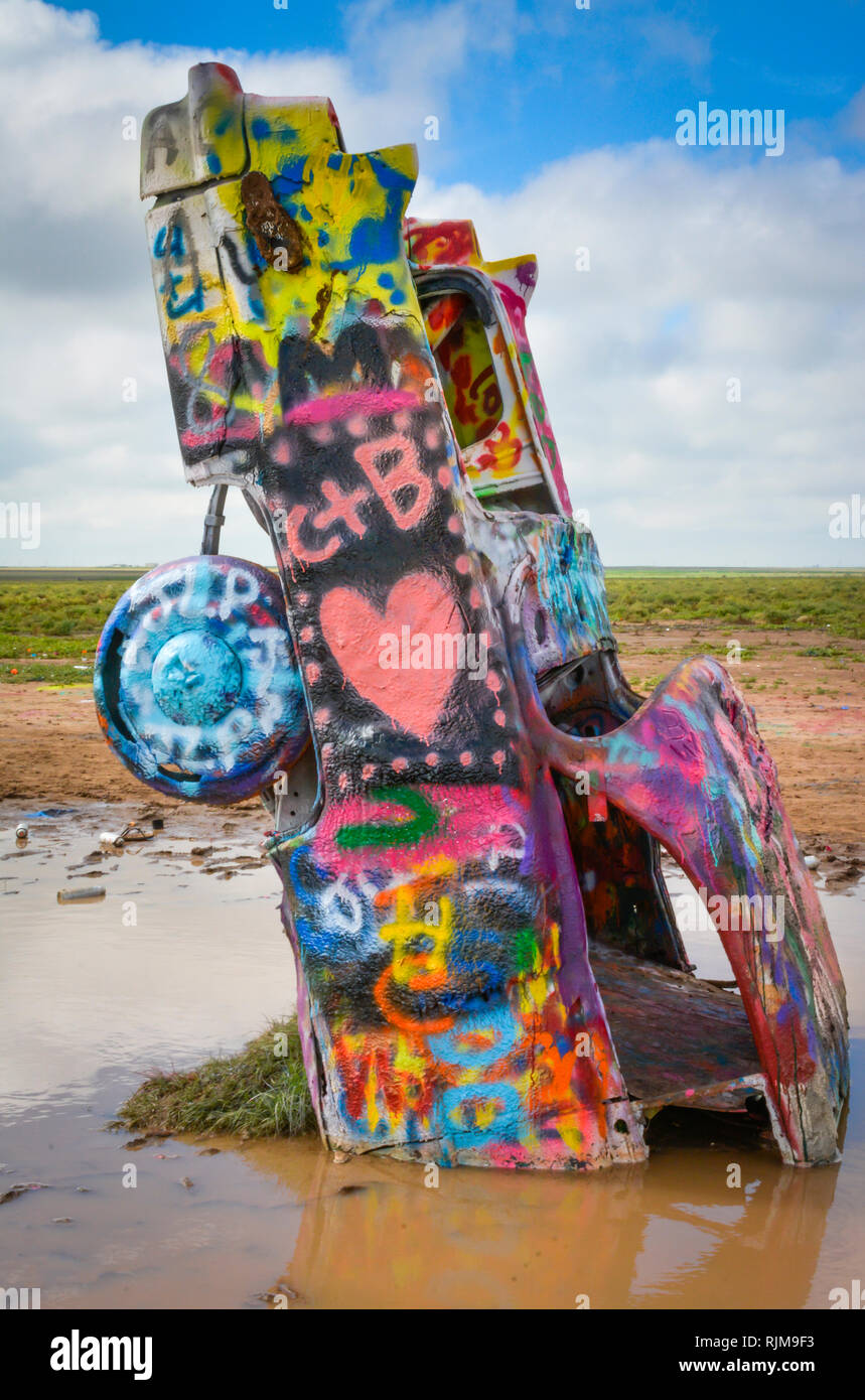Cadillac Ranch es una instalación de arte compuesta de viejos Cadillacs semienterrado, nariz hacia abajo, y pintado con spray diariamente por los visitantes cerca de Amarillo, TX Foto de stock