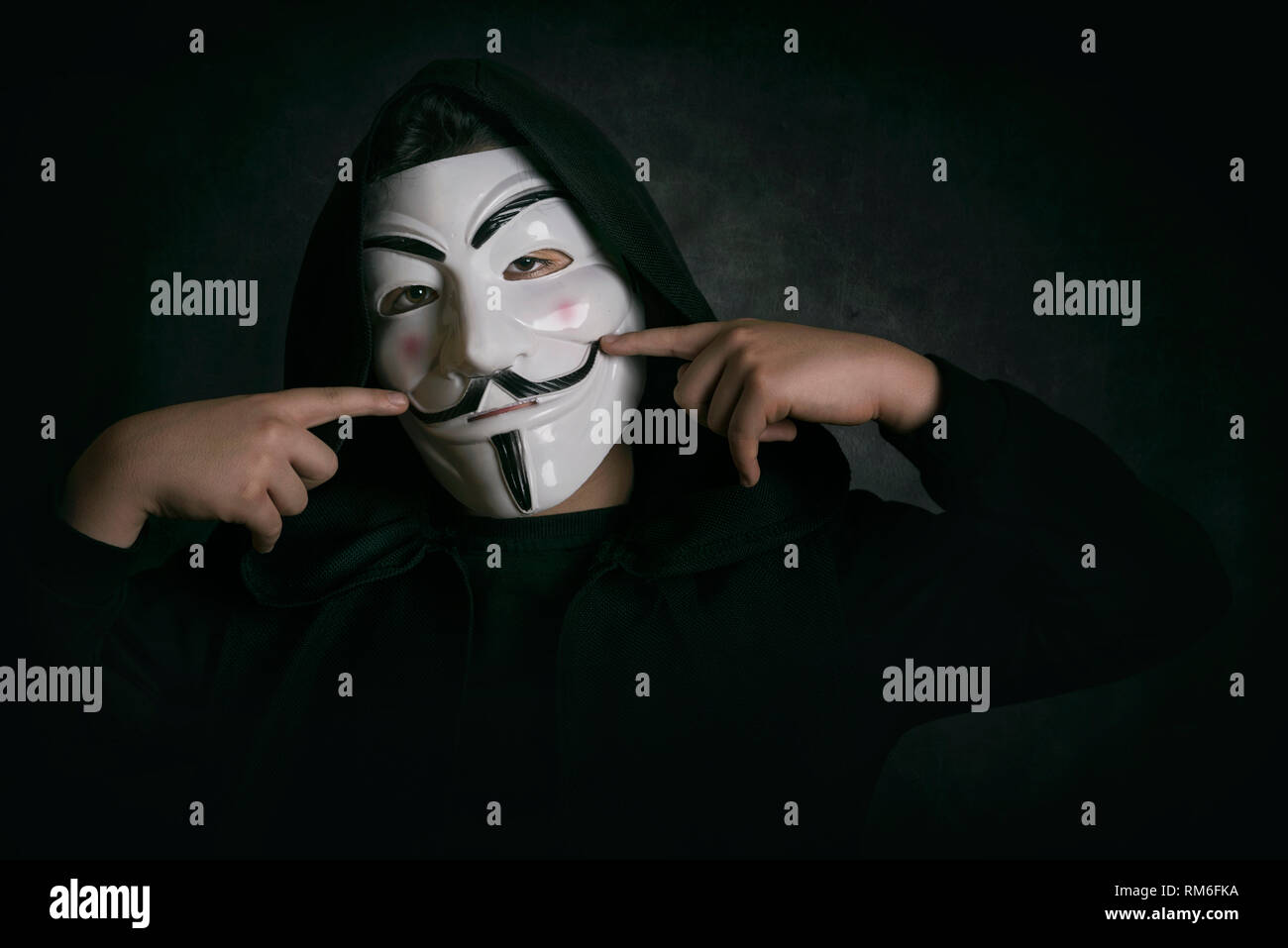 Hombre Sonriendo Con Anonimo De Enmascarar Sobre Fondo Negro Fotografia De Stock Alamy
