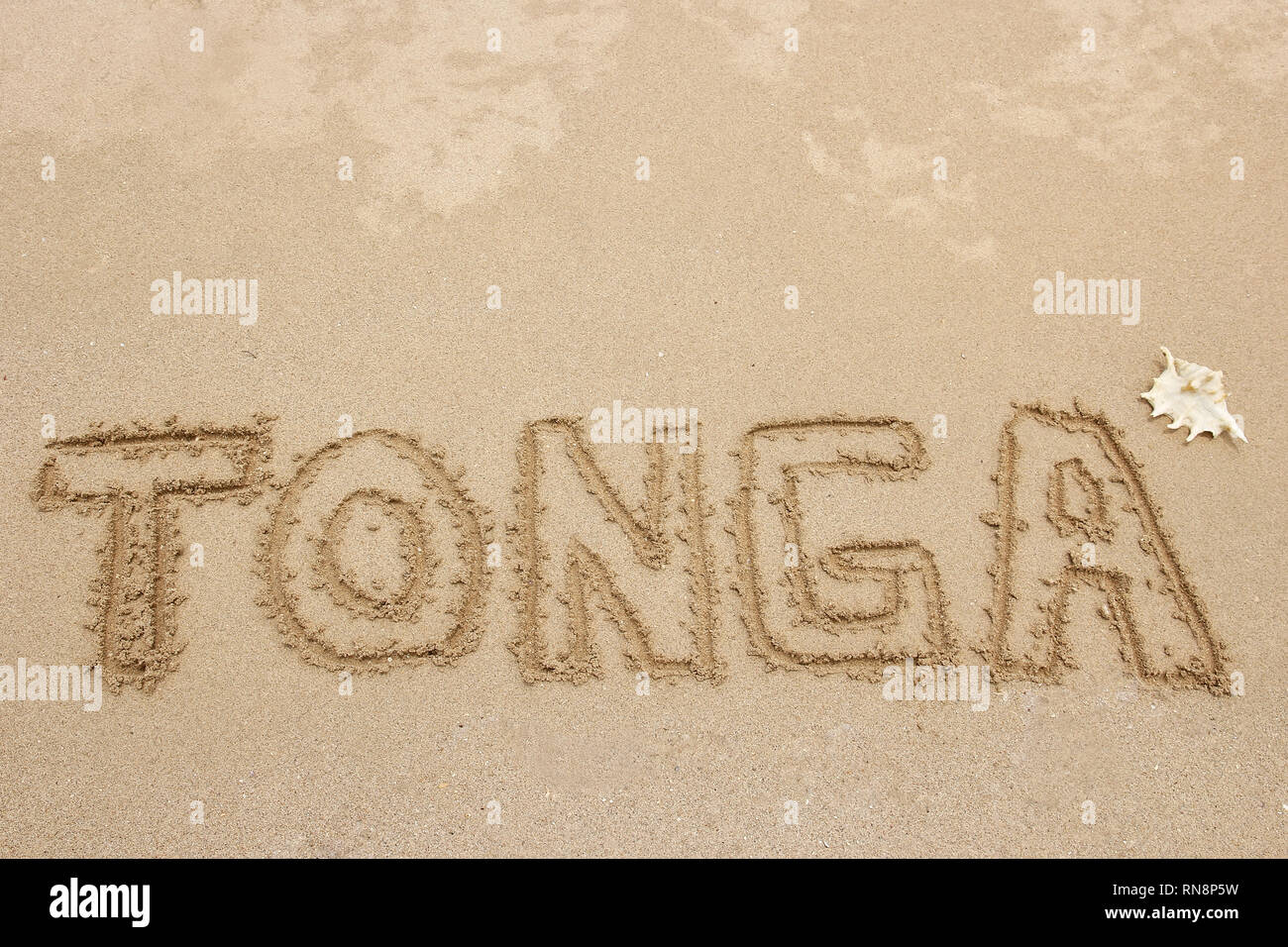 Palabra "Tonga" escrito en una arena - concepto de viaje Foto de stock
