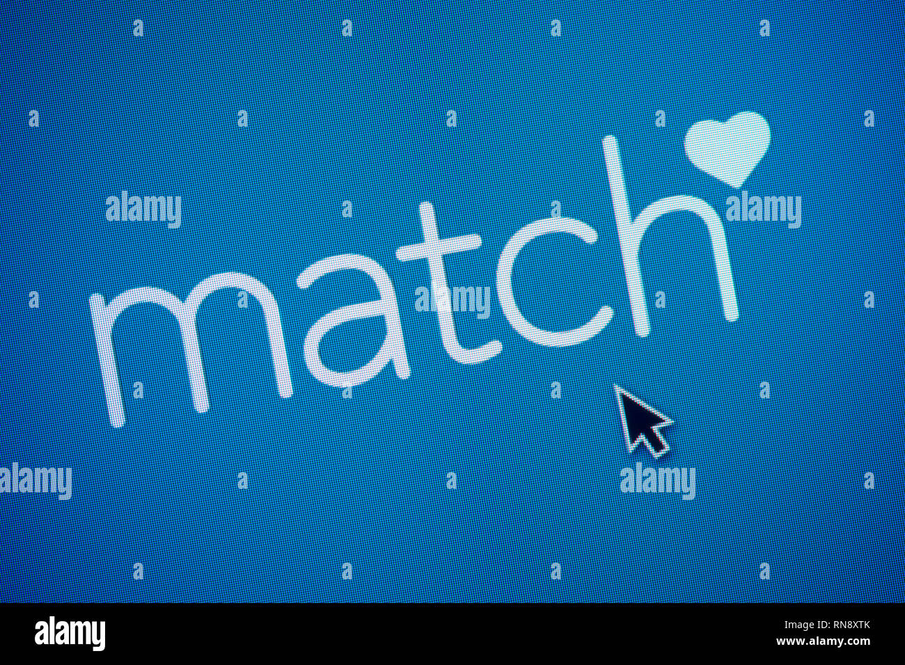 El logotipo de Match.com es visto en una pantalla de ordenador junto con el cursor del ratón (uso Editorial solamente) Foto de stock