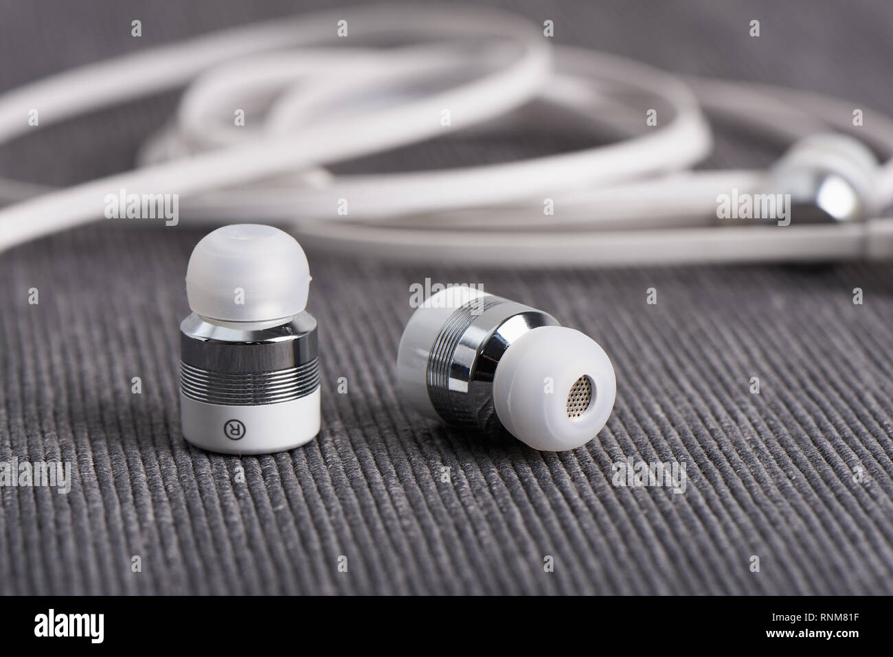 Auriculares Bluetooth inalámbricos inalámbrica sobre un fondo de cable auricular Foto de stock