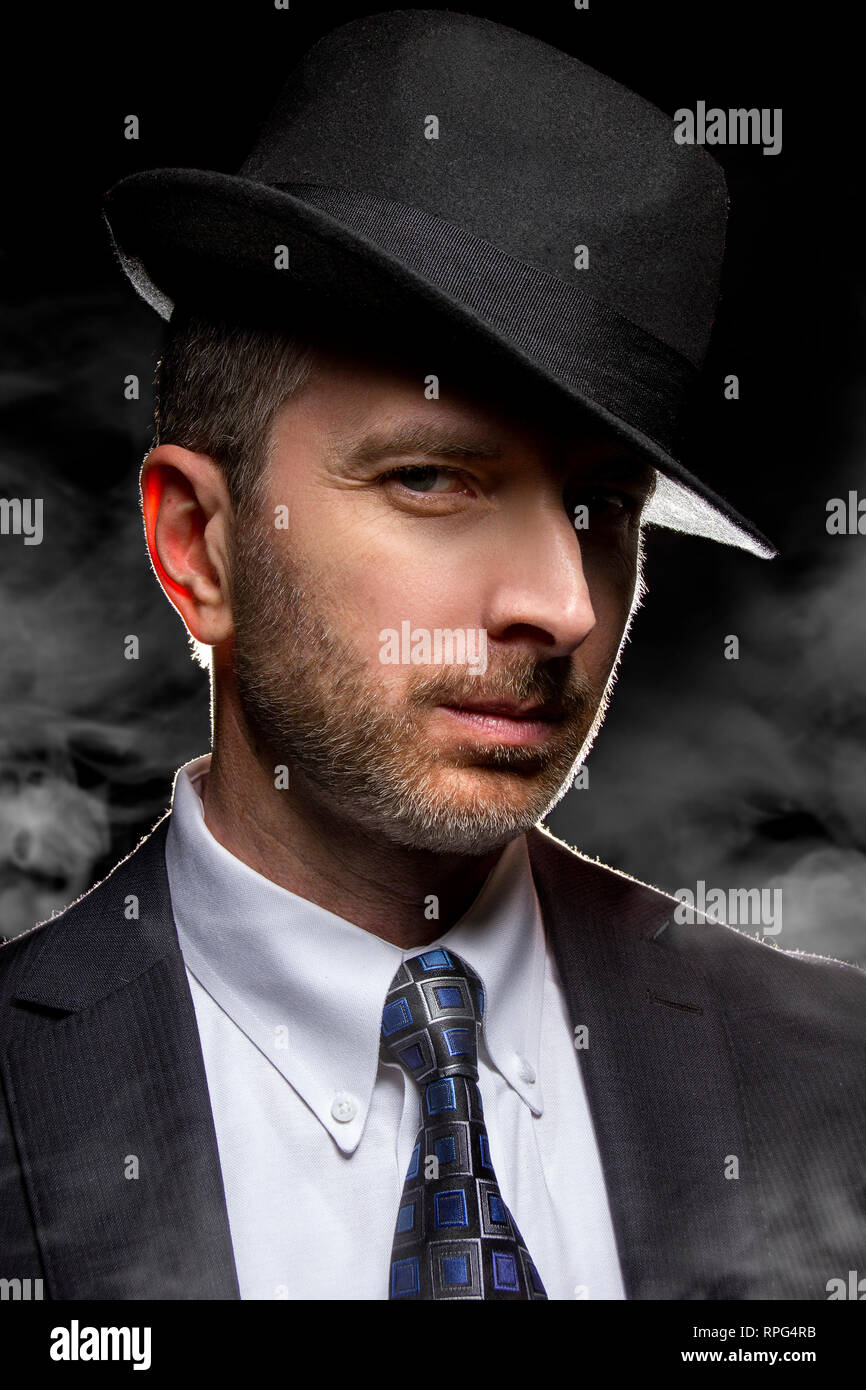 Hombre con un sombrero Fedora planteando como un film noir detective o  gangster Fotografía de stock - Alamy