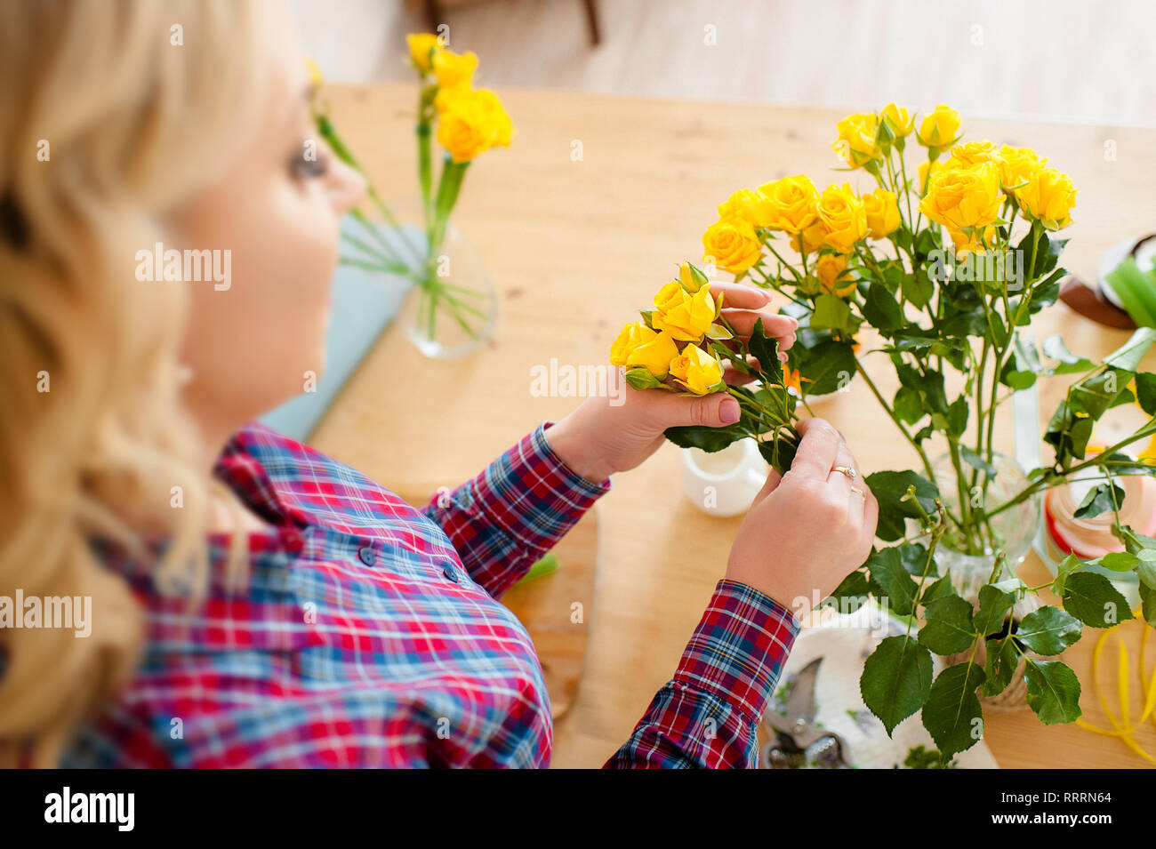 Las pequeñas empresas. Entrega de flores vista desde arriba. Floristerías creando el orden, haciendo rose bouquet en flower shop Foto de stock