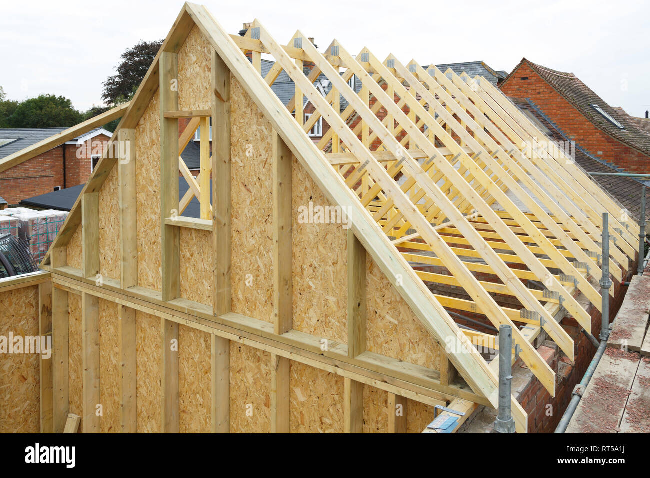 Gable y vigas de techo de madera a una casa en construcción de marcos de madera Foto de stock