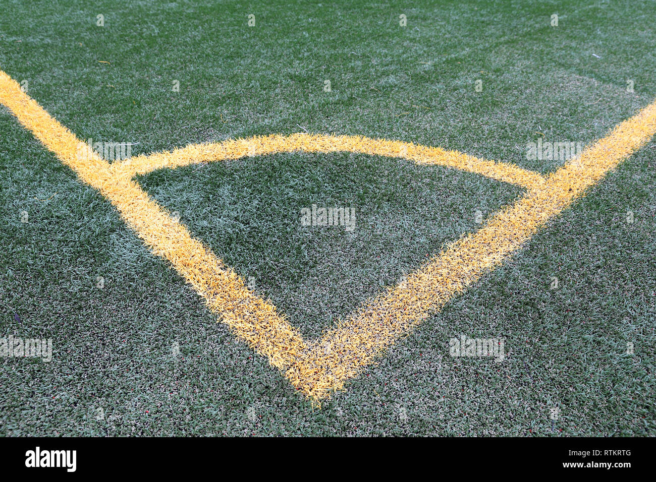 Esquina de fútbol fuera, las líneas amarillas sobre el verde césped artificial Foto de stock