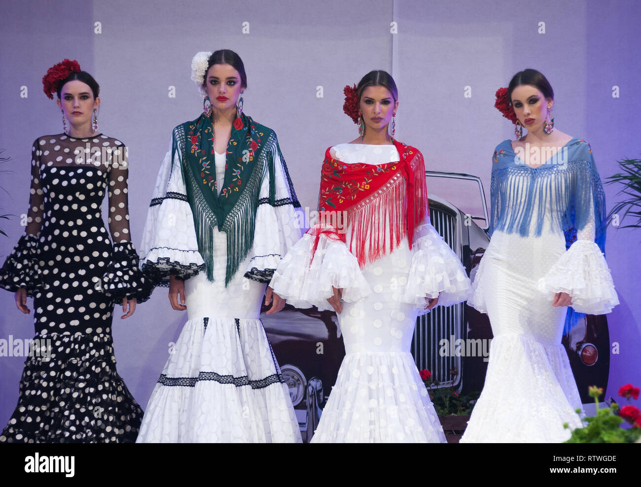 Málaga, Málaga, España. 2 Mar, 2019. Modelos vistos luciendo trajes de flamenca posando para los fotógrafos en la pasarela durante la IV Feria Internacional de la Moda Flamenca (FIMAF) en hotel