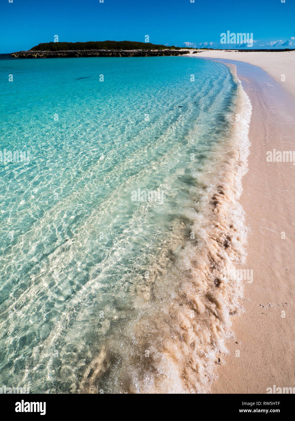 Ola golpeando la orilla de arena de Playa limpia, dos calas Playa, Eleuthera, las Bahamas, El Caribe. Foto de stock