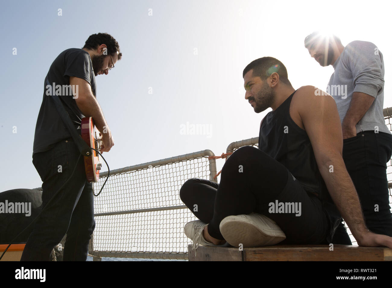 Banda libanesa Mashrou' Leila configurar y preparar para grabar una canción a bordo del barco de Greenpeace Rainbow Warrior en el sol nos une tour, el Mar Mediterráneo, el 23 de octubre de 2016. N38°01.500' E9°45.172' Foto de stock
