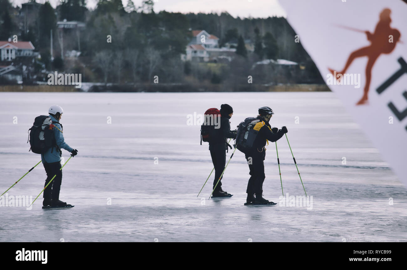 Los patinadores sobre hielo de larga distancia con polos de hielo sobre el lago Malaren, Sigtuna, Suecia, Escandinavia Foto de stock