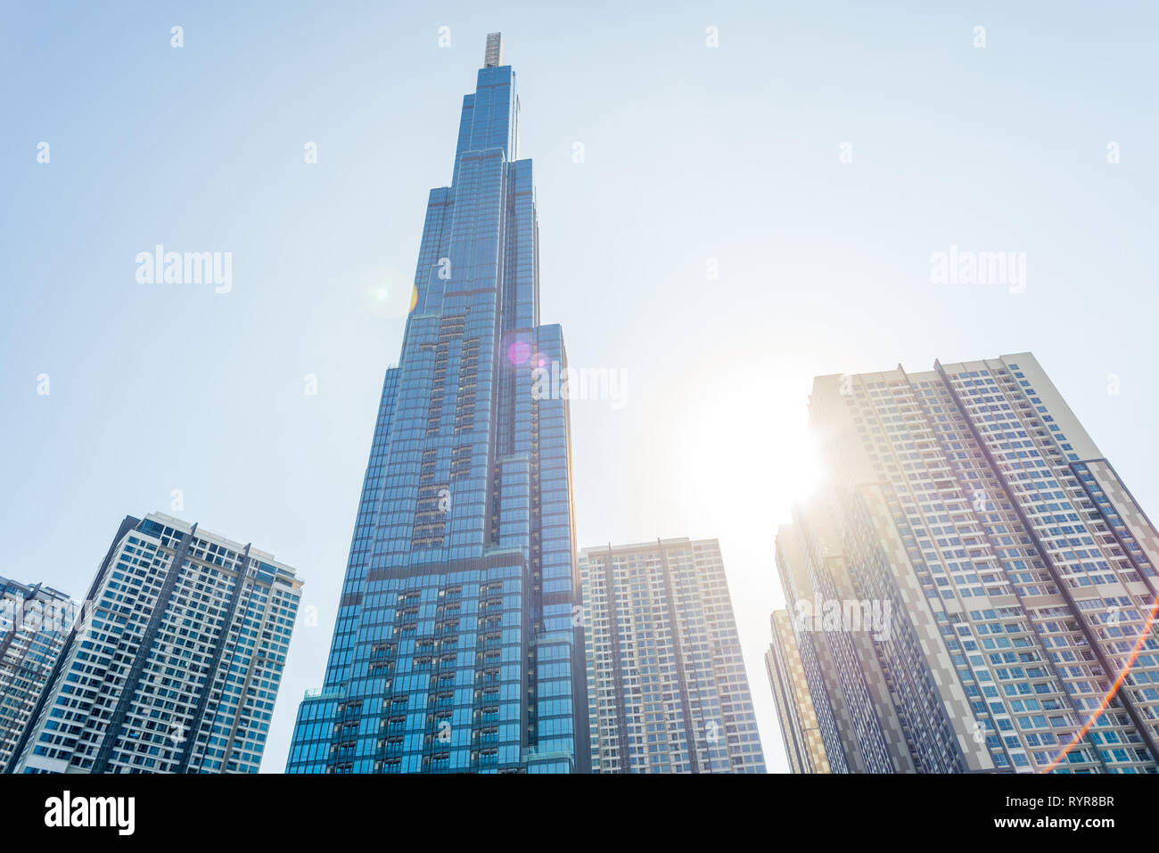 Ho Chi Minh, Vietnam - Febrero 19, 2019: Landmark 81 contra el cielo azul con el sol brillando y destellos de lente. Foto de stock