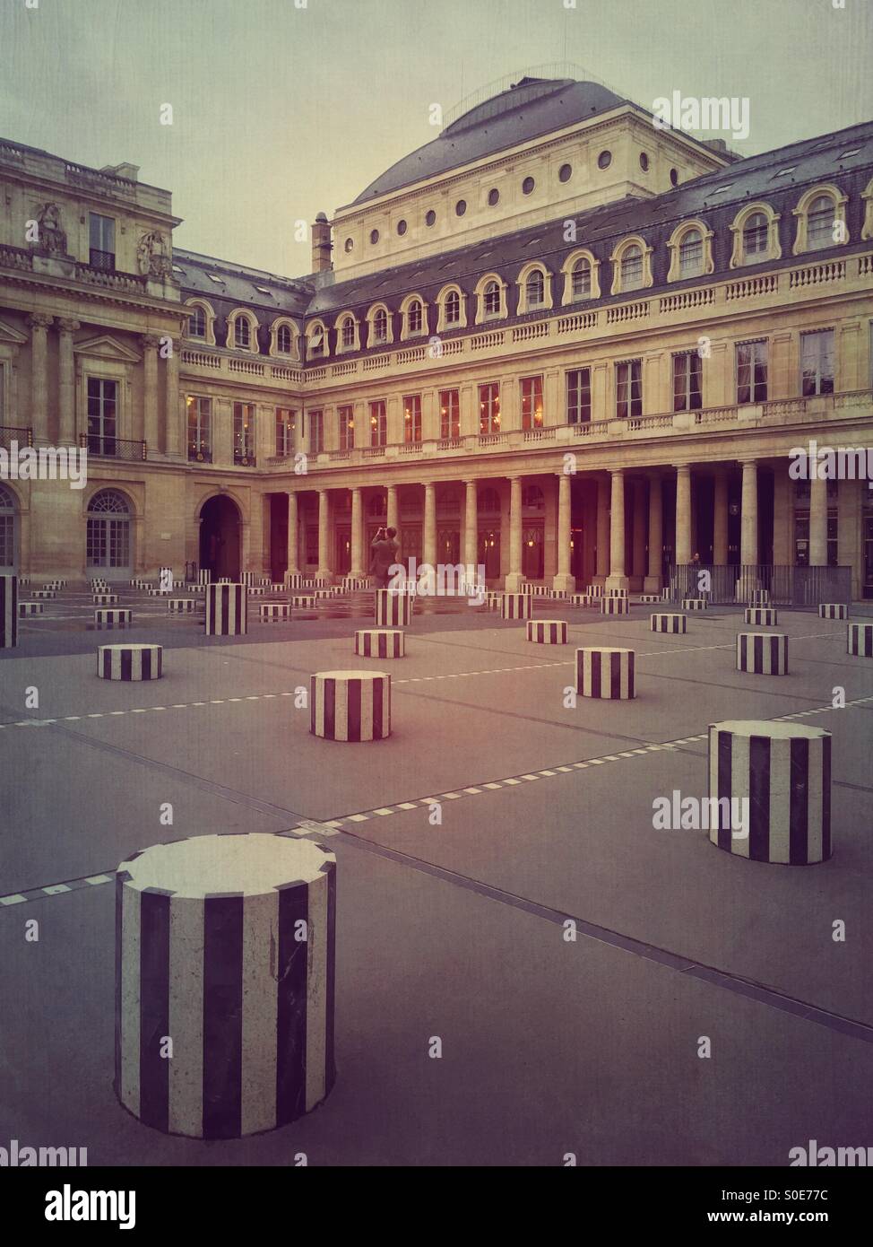 Vista del patio principal en la Place du Palais-Royal en París, Francia. Les Deux Plateaux instalación por Daniel Buren compuesto de cilindros seccionados hecha de mármol blanco de Carrara y negro mármol pirenaico. Foto de stock