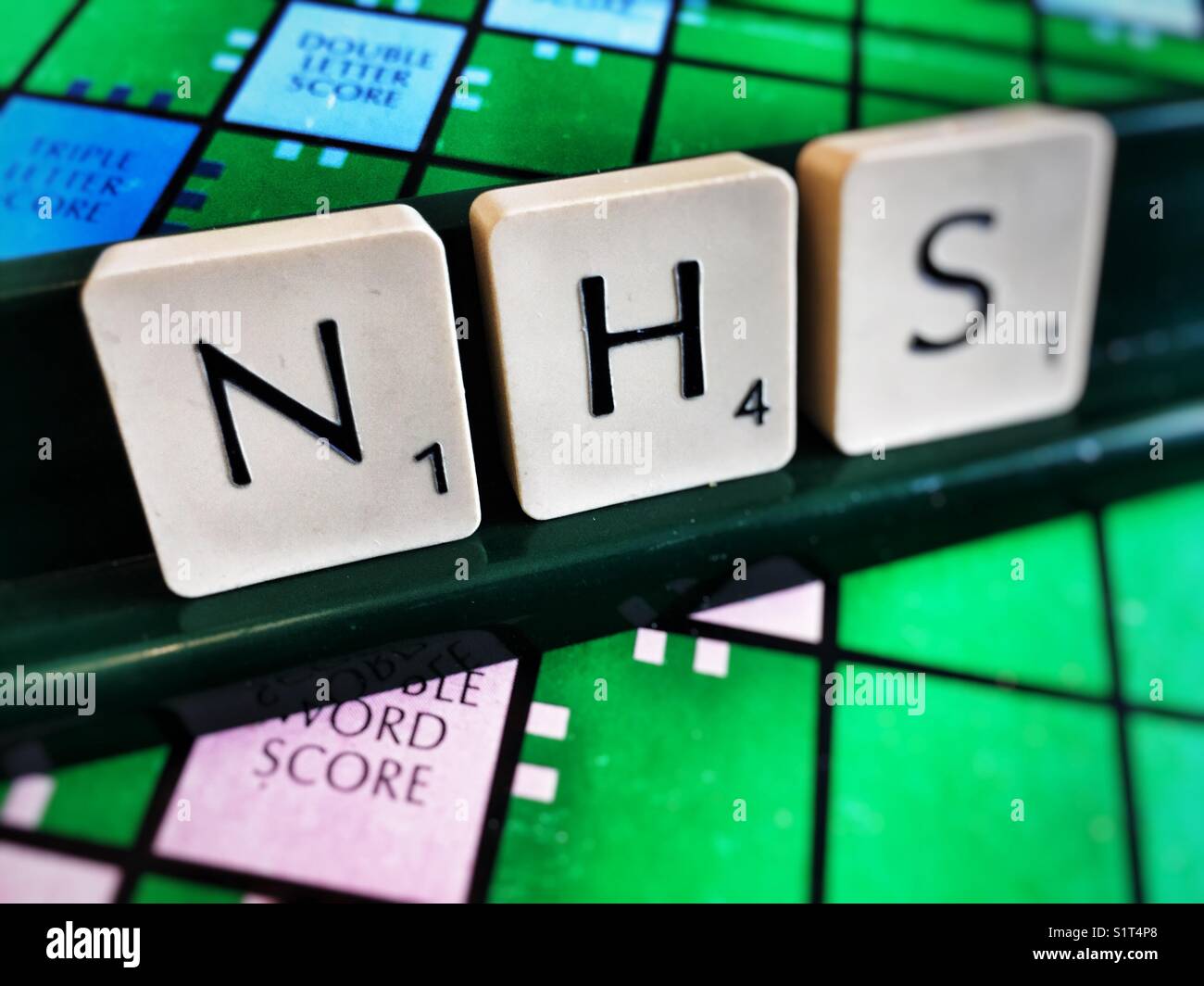 NHS (Servicio Nacional de Salud) escrito con azulejos scrabble Foto de stock