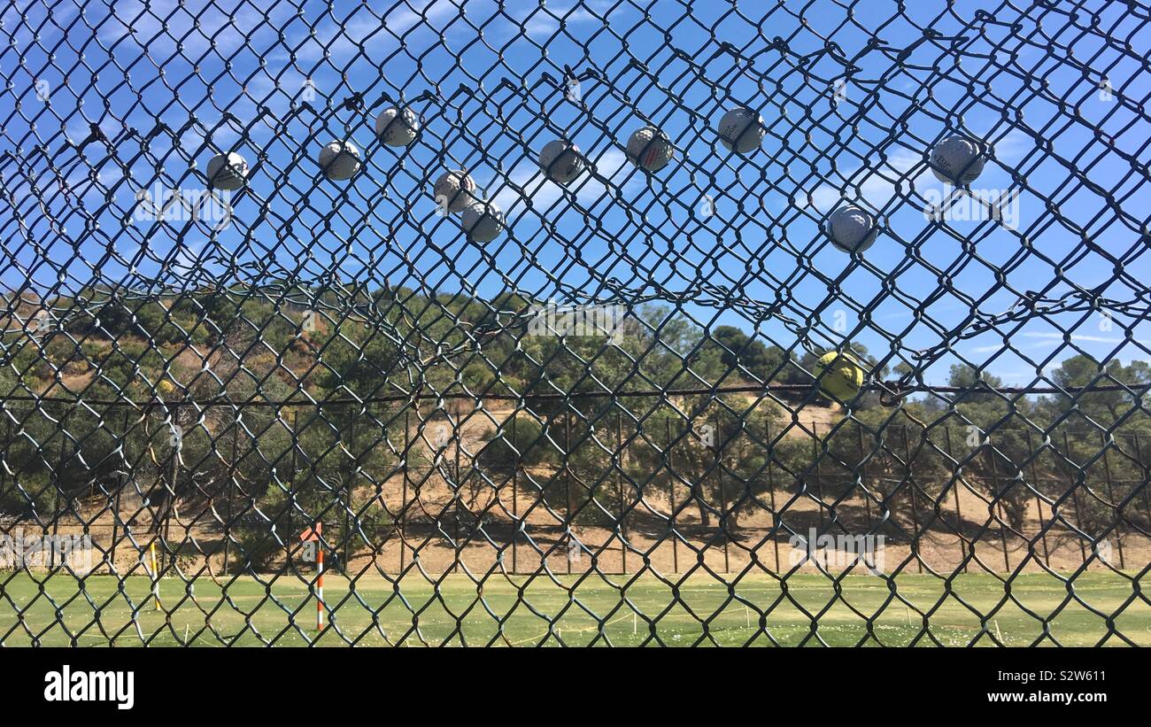LOS ANGELES, CA, Aug 2019: pelotas de golf atascado en la valla de tela  metálica en el driving range en el Parque Griffith Fotografía de stock -  Alamy