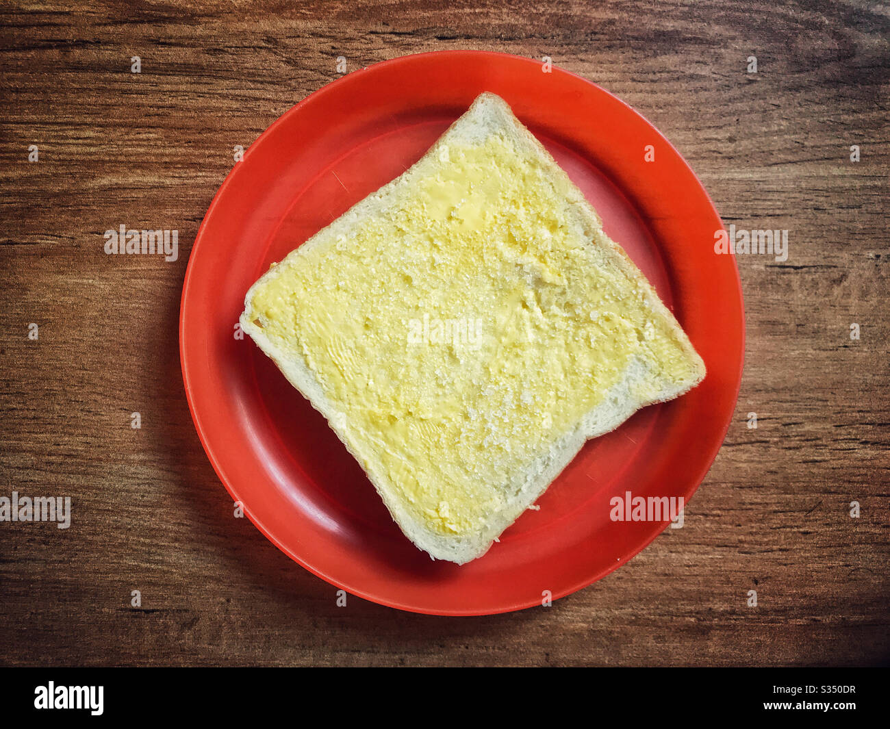 Una rebanada de pan con mantequilla y azúcar Fotografía de stock - Alamy