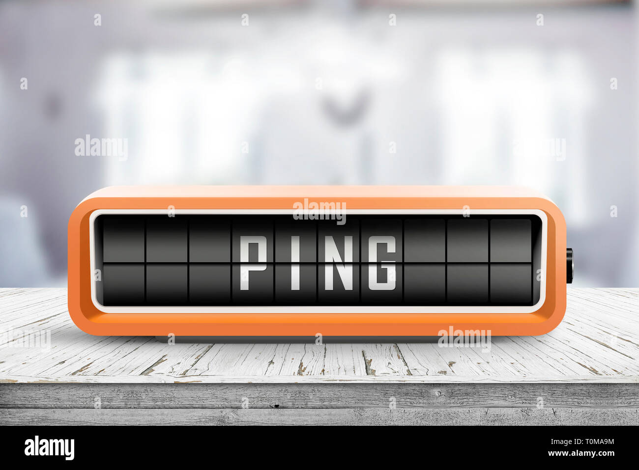 Dispositivo de retro con la palabra Ping sobre una mesa de madera en una habitación Foto de stock
