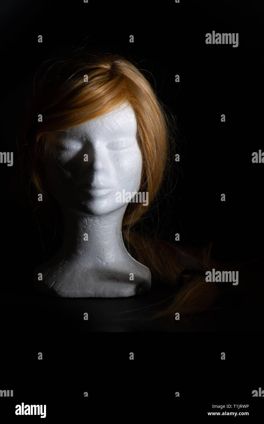 Peluca rubia en una cabeza de poliestireno sobre un fondo negro Fotografía  de stock - Alamy