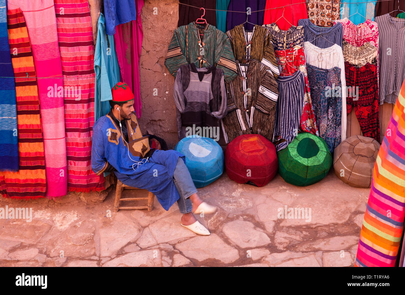 Un vendedor bereber vendiendo ropa en el ksar Aït-Ben-Haddou, Aït Benhaddou‌, Provincia de Ouarzazate, Drâa-Tafilalet, Marruecos, África. Foto de stock
