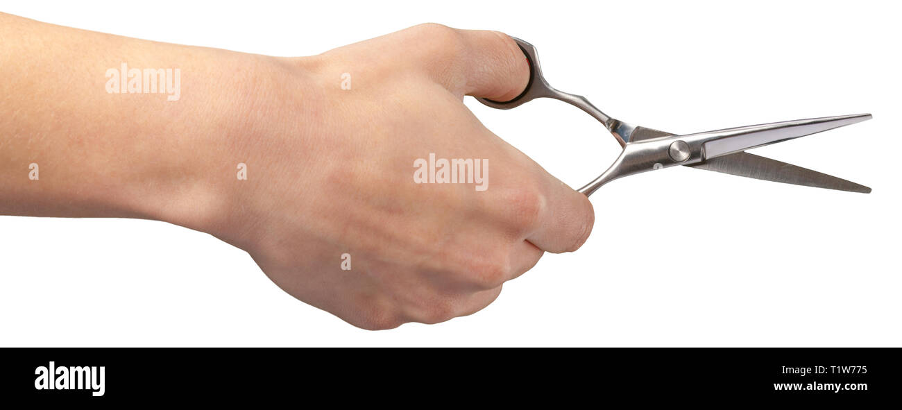 La mano de un peluquero sosteniendo una tijera Fotografía de stock - Alamy