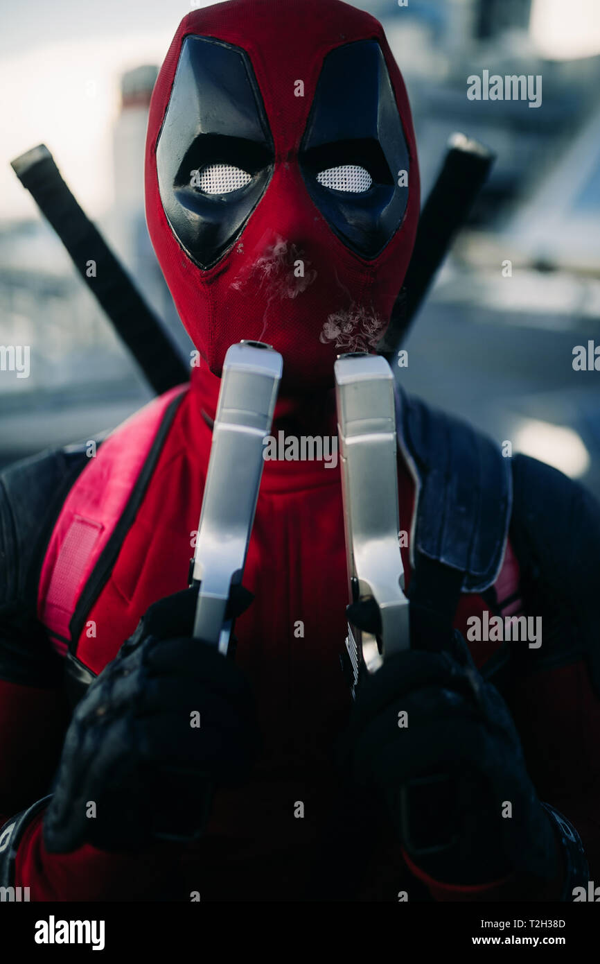 DNIPRO, Ucrania - Marzo 28, 2019: Retrato de Deadpool cosplayer con dos  pistolas en sus manos y las katanas detrás de su espalda Fotografía de  stock - Alamy