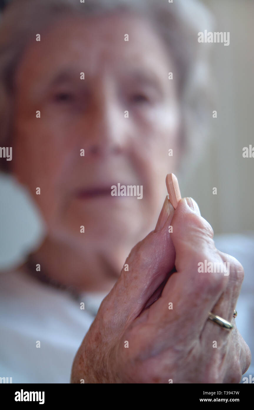 Mujer mayor tomando medicamento Foto de stock