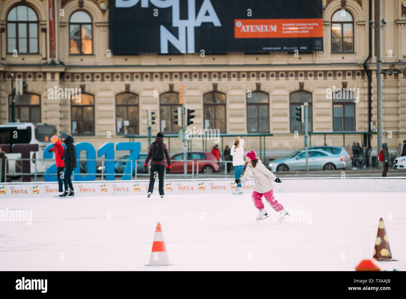 Helsinki, Finlandia - 11 de diciembre de 2016: Jóvenes y Niños patinando sobre hielo en la Plaza del Ferrocarril en el día de invierno. Foto de stock