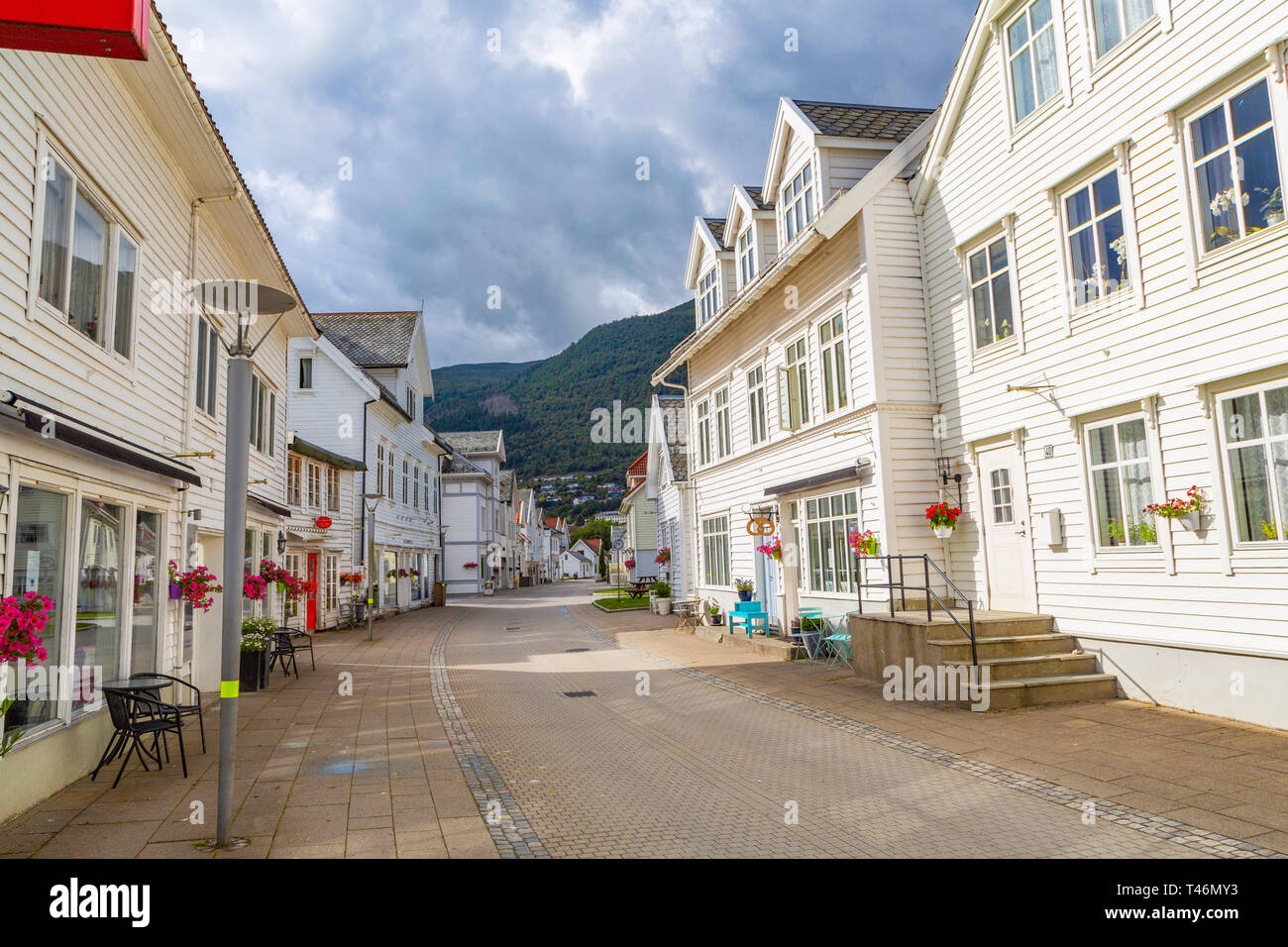 Nordfjordeid, Noruega - Julio 2016: Calle Principal de la ciudad con un Nordfjordeid edificios blancos de estilo retro. Calle curvada con casas blancas en el casco antiguo de Niza histor Foto de stock