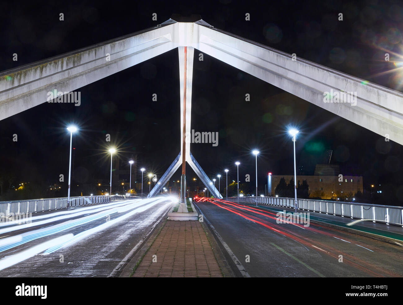 El "Puente de la Barqueta' Puente en Sevilla iluminada por la noche Foto de stock