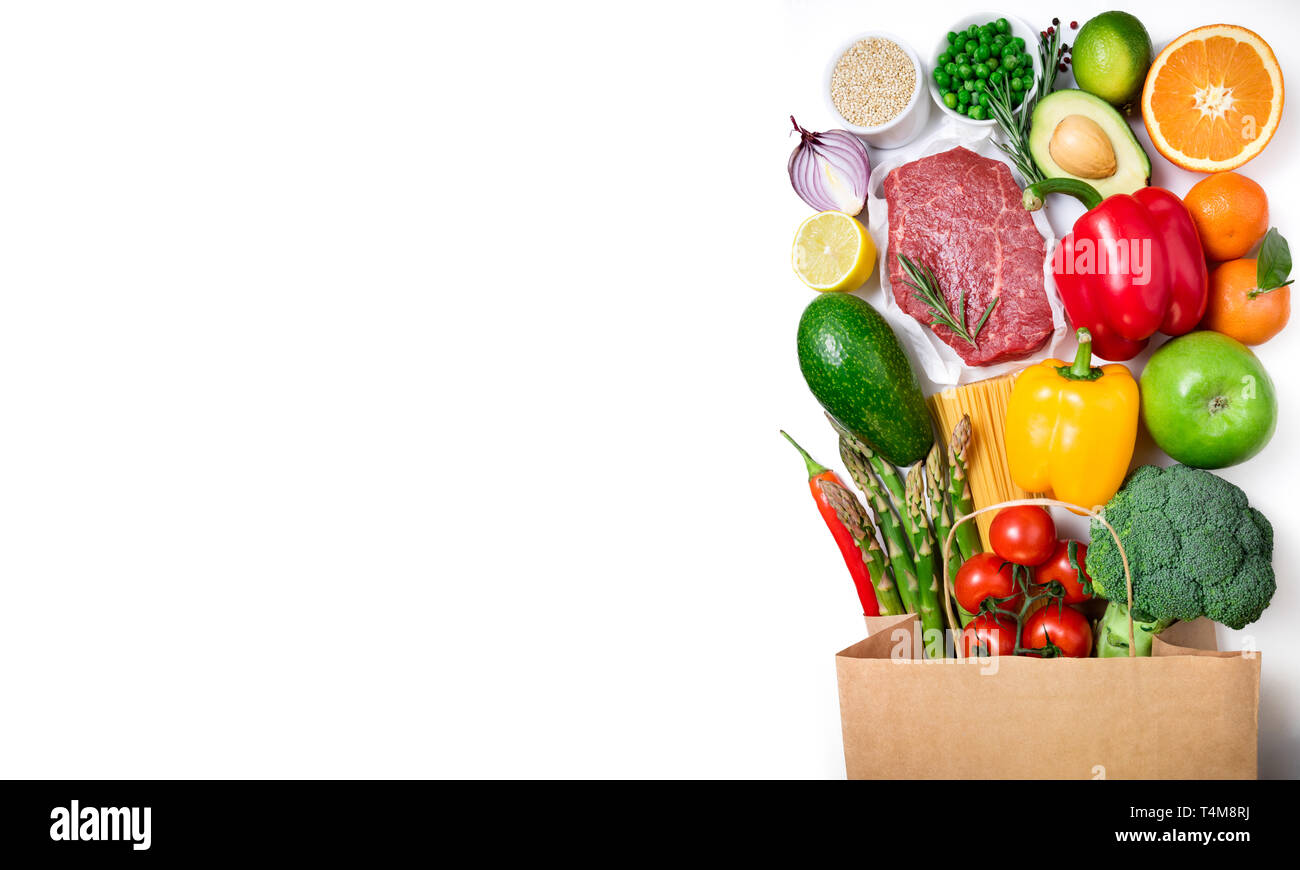 Fondo de alimentos saludables. Alimentos saludables en la bolsa de papel de vacuno de carne, frutas, verduras y pasta sobre fondo blanco. Concepto de supermercado de compras. Lon Foto de stock