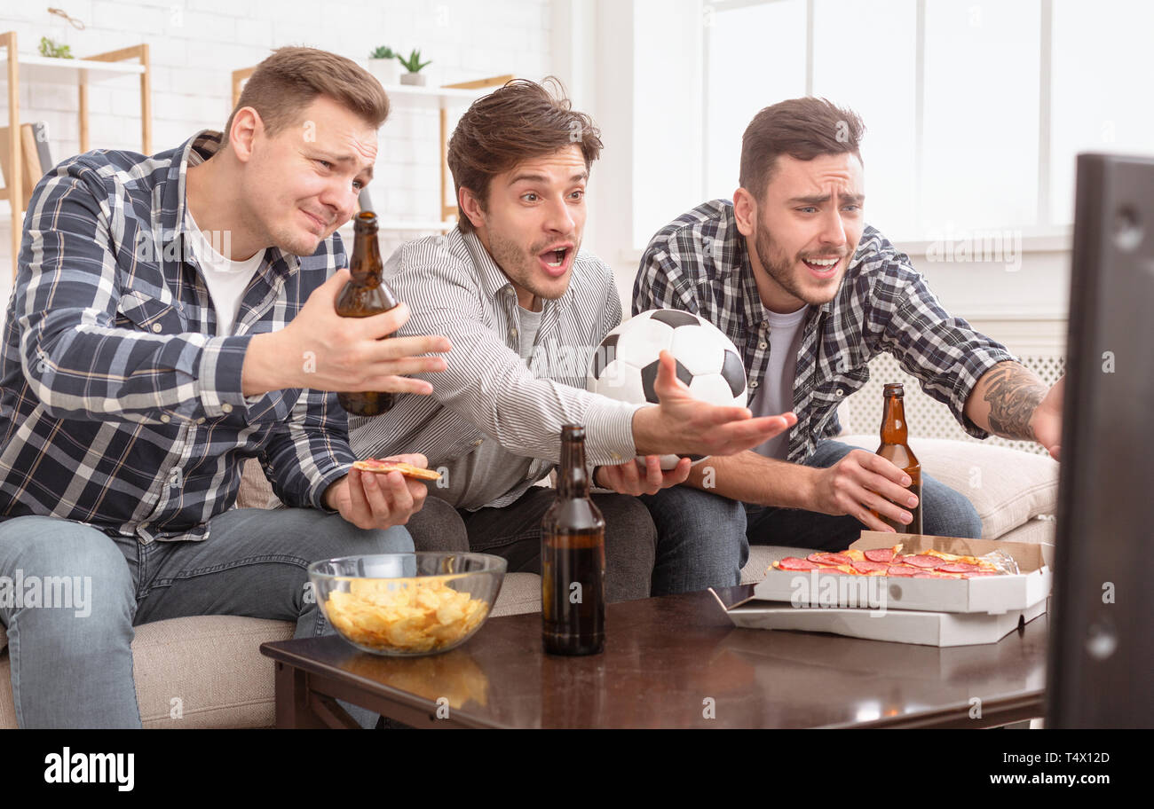 Decepcionado amigos viendo el fútbol juego, molesto por la pérdida Foto de stock