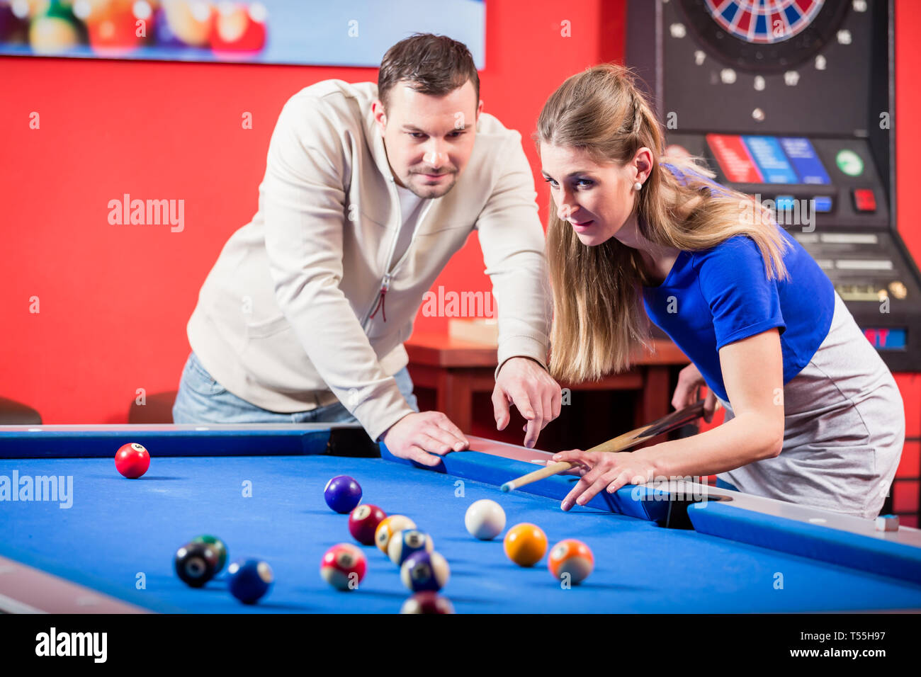 Mujer recibiendo asesoramiento sobre disparar bolas pool mientras juega  billar Fotografía de stock - Alamy