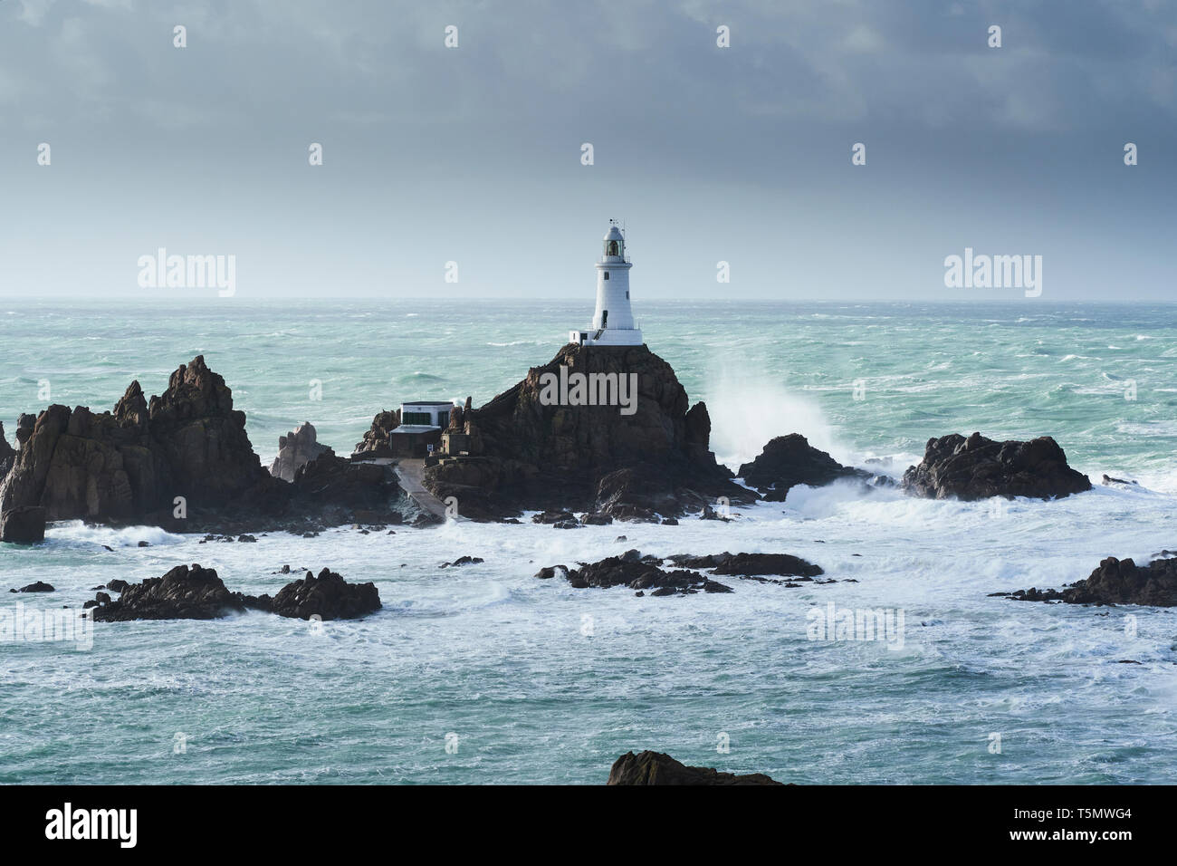 La Corbiere lighthouse en una tormenta de invierno, Jersey, Islas del Canal Foto de stock