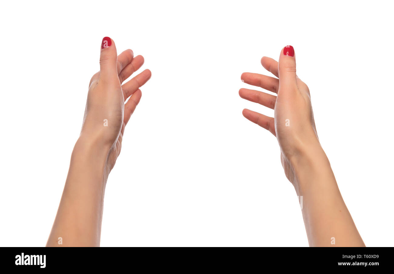 Mujeres manos sosteniendo algo invisible o tirando manos sobre fondo blanco. Foto de stock